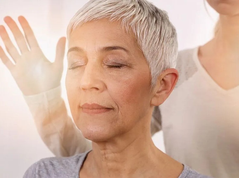 two women practicing energy healing